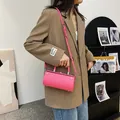 Hot pink cylindrical handbag in shiny leather with silver clasp and shoulder strap - Pink