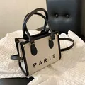 Bolso tote de lona crema con ribete de cuero negro y estampado de logo Paris - Pequeño Negro