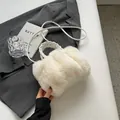 Furry ivory faux fur tote bag with woven handle and leather strap on a stylish desk - Off White