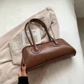 Vintage brown leather Boston shoulder bag with gold zipper on cream blazer - Brown