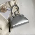 Minimalist silver metallic underarm bag with sleek liquid metal finish and slim handles - Silver