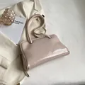 Elegant beige pink leather underarm bag with long shoulder strap in minimalist style - Off White