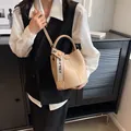 Elegant beige bucket bag with lychee grain texture and branded wide crossbody strap - Khaki