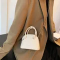 Chic beige half-moon crossbody bag with pearl chain and fashion logo for women - White