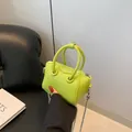 Mini lime green litchi grain leather crossbody bag with silver chain and dual handles - Green