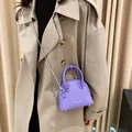Elegant purple shell-shaped mini bag with lychee texture and silver ball chain strap - Purple