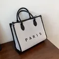 Bolso tote de lona minimalista en beige y negro con letras PARIS y asas de cuero fino - L Negro