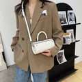 Minimalist white cylindrical bucket bag with a top handle and adjustable shoulder strap - White