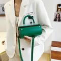 Chic green cylinder handbag in glossy faux leather with silver studs and top handle - Green