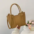 Chic tan pebble leather bucket bag with fixed handles and detachable shoulder strap - Brown