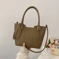 Dark brown pebble leather bucket bag with top handle and adjustable shoulder strap - Mocha Coffee