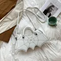 White bat-shaped gothic handbag with black cobweb embroidery and detachable strap - White