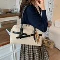 Off-white faux suede crossbody bag with contrast black trim and bohemian beaded charm detail - With Pendant / Khaki