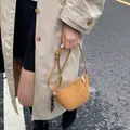 Handmade camel leather half-moon crossbody bag with heart charm and woven details - Brown