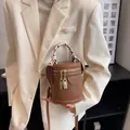 Vintage brown cylindrical bucket bag with silk scarf handle and golden lock charms - Brown