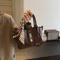 Dark brown retro bucket bag with silk scarf handle and silver twist lock mechanism - Brown