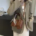 Dark brown leather bucket bag with silk scarf accent and adjustable shoulder strap - Brown
