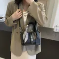 Black lychee texture bucket bag with geometric scarf handle and silver buckle - Black