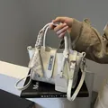 Creamy white bucket handbag with silk scarf handle and elegant metal twist lock detail - Silver