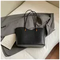 Minimalist black woven tote bag for women with golden metal hardware on a white surface - Basic Style / Black