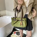 Avocado green frosted tote bag with brown leather straps and beaded tassel detail - Green