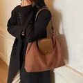 Caramel vintage suede tote bag with leather trim worn by model in a stylish interior - Coffee