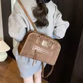 Brown vintage suede tote bag with fringe detail and shoulder strap shown on model - Brown