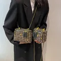 Detail of tweed quilted box bags with gold flower accents and chain straps for women - Large / Black