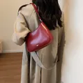 Chic burgundy leather half-moon underarm bag with minimalist adjustable strap - Burgundy