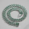 Macro detail of silver-tone Cuban link necklace with iced-out green crystals and box clasp - 20 Inch (50cm) / Silver / Green