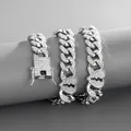 Close-up of iced out silver Cuban chain with broken heart links on a gray jewelry stand - Necklace (45cm) / Silver