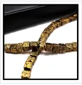 Close-up of gold cubic lava stone beads with textured vintage metallic finish for DIY jewelry - Antique Gold