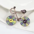 Vintage bronze bicycle brooch with colorful enamel wheels and purple crystal accents - Vintage Multicolor Bicycle Style
