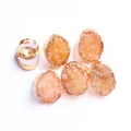 Macro detail of natural druzy agate rings with gold-plated adjustable bands - Orange