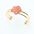 Golden double-loop open bangle featuring a carved pink natural stone flower design - Watermelon red