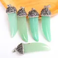 Macro detail of five horn-shaped light green natural stone pendants with pavé crystal accents - Green Aventurine