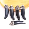 Detail of horn pendants with polished black stones and glittering rhinestone accents - Obsidian
