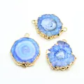 Close-up of blue agate druzy pendants with gold plated edges on a white background - Sapphire Blue
