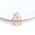Detail eines vergoldeten Krallenrings mit natürlichen Rosa Kristallen auf weißer Keramik - Weiß Kristall