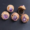 Macro detail of gold-plated rings featuring natural amethyst crystals and pavé rhinestones - Amethyst