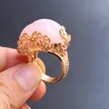Detailed view of an adjustable gold hollow ring featuring a pink quartz stone inlay - Rose Quartz