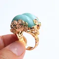 Vintage gold ring featuring hollow flower and butterfly motifs with dual green gemstones - Adjustable Open / Green Aventurine