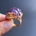 Detailed macro view of vintage gold ring with dual purple amethyst stones and floral details - Amethyst