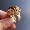Vintage gold ring featuring a natural tiger eye stone with hollow flower engravings - Adjustable Open / Tiger's Eye