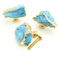 Macro detail of blue crystal stone drawer knobs with gold foil edges and brass base - Blue Stone