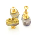 Macro view of natural crystal cluster drawer handle with brass base and screw details - Yellow