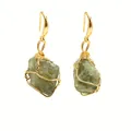 Detail of light green raw crystal earrings with handmade gold wire wrapping craftsmanship - Moonstone