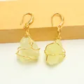 Detail of wire-wrapped earrings featuring irregular natural stones in a gold setting - Lemon Yellow