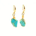 Macro shot of handmade gold wire-wrapped irregular turquoise drop earrings with natural textures - Synthetic Turquoise