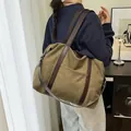 Large olive green canvas tote bag with brown leather straps for everyday commuting use - Green